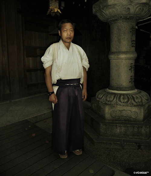 Portrait of a japanese monk standing next to the stone pillar SKU: po-0003